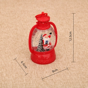 Detail view of 12.5cm red Christmas lantern with Santa and snow globe liquid feature