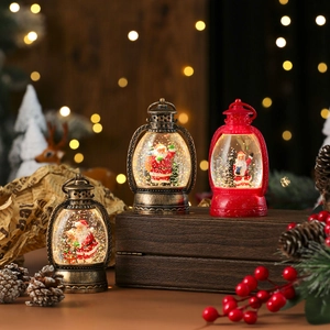 Three Christmas snow globe lanterns with warm lights on a vintage wood display