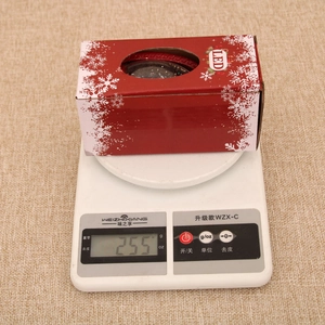 Detail shot of the LED Christmas lantern gift box on a digital scale weighing 255g