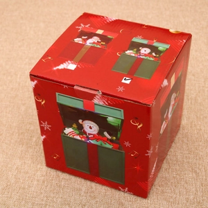 Detail view of a festive red Christmas music gift box with Santa and snowman patterns