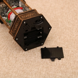 Detail view of the bottom power switch and battery compartment of the Christmas lantern