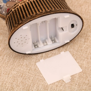 Macro view of the Christmas lantern base featuring the battery compartment and speaker