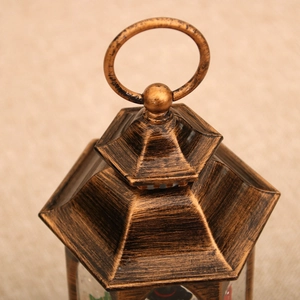 Close-up of vintage bronze Christmas lantern top with ring handle and metallic texture