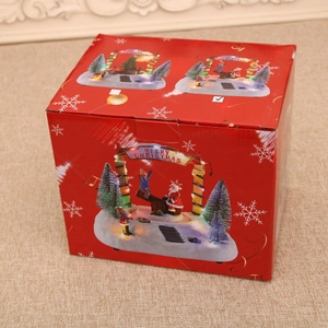 Close-up of the red Christmas music box gift packaging featuring festive scene illustrations