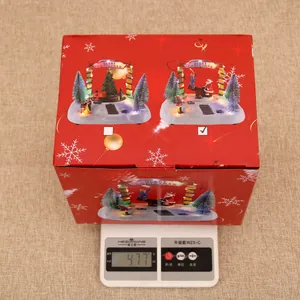 Christmas musical box in a red themed gift box weighing 477g on a digital scale