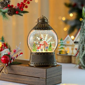 Close-up of vintage bronze snow globe lantern with snowman and swirling gold glitter