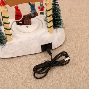 Detailed view of the USB power port on the resin Christmas music box with snowy base