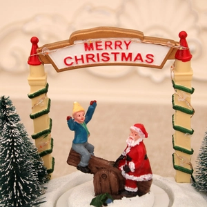 Macro detail of Santa Claus on a seesaw with Merry Christmas arch and festive trees