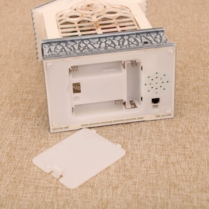 Detail of the bottom compartment showing 3 AAA battery slots and speaker for music box