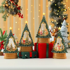 Lighted musical Christmas tree snow globe set with festive miniature scenes and gold base