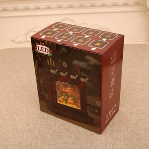 Christmas fireplace music box packaging with LED light specs and festive snow globe artwork