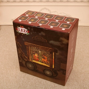 Detailed view of the Christmas LED music box retail packaging with Santa sleigh imagery