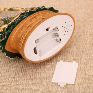 Detail of bronze-gold base with battery compartment and switch for musical Xmas tree