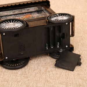 Detail of vintage Christmas cart base with battery compartment and power switch