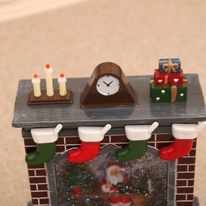 Macro view of Christmas fireplace music box with Santa scene and festive stocking details