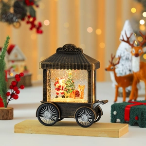 Macro detail of a vintage Christmas carriage snow globe with Santa and glowing lights