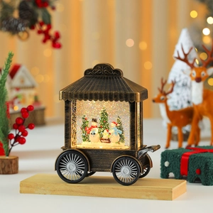 Detail of vintage bronze Christmas snow globe lamp featuring snowman family and snowy scene