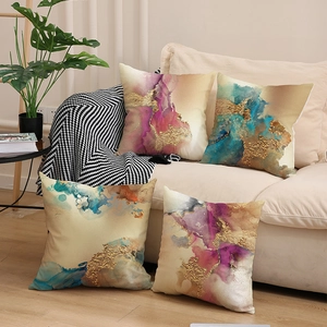 Set of 4 Nordic throw pillows with gold-accented abstract fluid art on a beige sofa