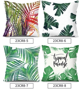 Set of four tropical plant pillow covers with palm leaves and monstera prints in green