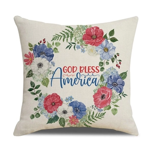 Detail of linen pillow cover with floral wreath and God Bless America print