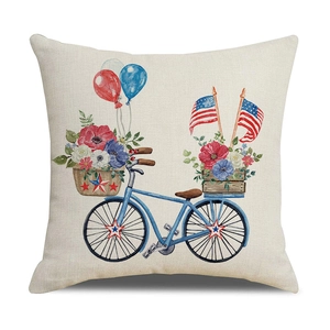 Close-up of linen pillowcase with blue bicycle, flowers and American flag elements