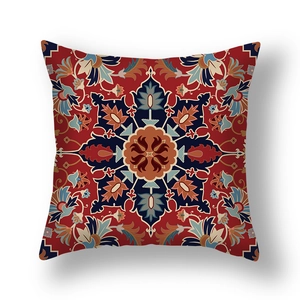 Detail of red Persian style pillow cover with vintage floral bohemian print and plush texture