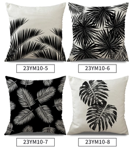 Set of four linen pillow covers featuring black and white tropical leaf patterns and textures