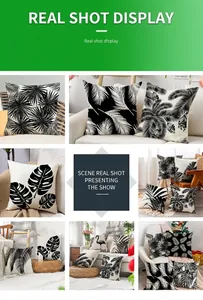 Linen pillow cover featuring black and white tropical leaf patterns in a home setting