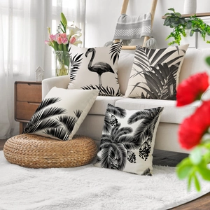 Set of four tropical linen pillow covers with black and white flamingo and palm leaf prints