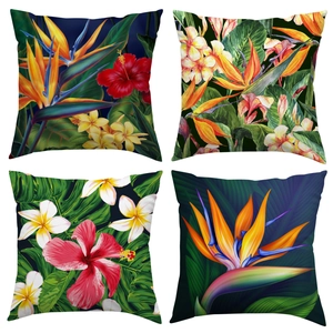 Set of four tropical pillow covers featuring bird of paradise and hibiscus floral prints