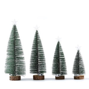Set of four mini snow-flocked Christmas trees with glowing lights and natural wood bases