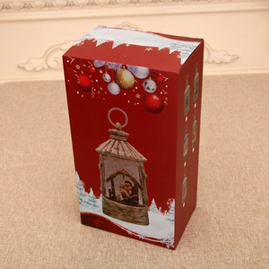 Vertical red Christmas gift box featuring vintage lantern illustration and festive snow scenes