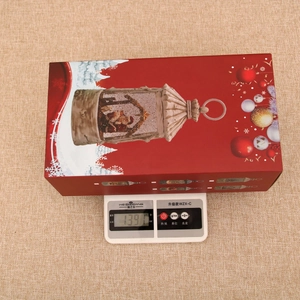 Christmas snow globe lantern packaging showing the product gross weight of 1391g