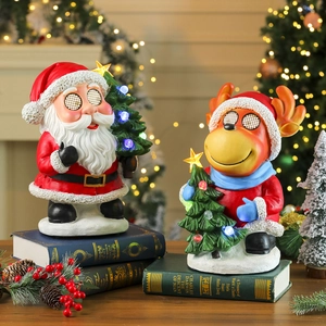 Lighted Santa and reindeer resin figurines with glowing trees for Christmas decor