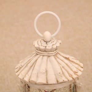 Close-up of vintage Christmas snow globe lid with cream white bark texture and ring handle