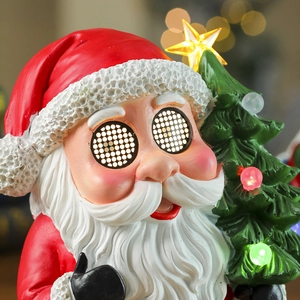 Close-up of glowing Santa Claus figurine with LED Christmas tree and warm bokeh background