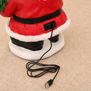 Detail of Santa Claus music box showing the USB power port and 3-way toggle switch control