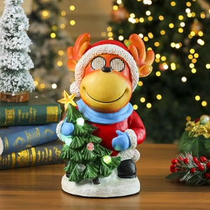 Detailed view of reindeer figurine holding a small LED Christmas tree on a snow base