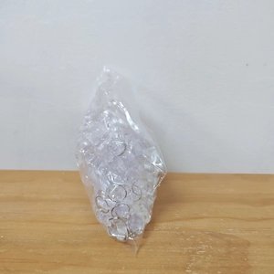 Bulk clear acrylic icicle ornaments and silver rings packaged in a clear poly bag