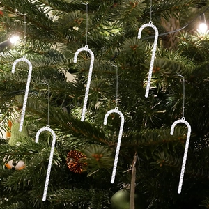Set of 6 textured acrylic candy cane ornaments hanging on a festive lighted Christmas tree