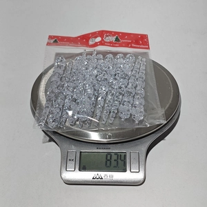 Close-up of 83.4g weight measurement for clear acrylic Christmas icicle ornaments