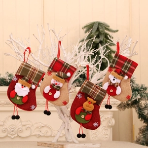Set of 4 Christmas stockings with Santa and Reindeer hanging on festive branches