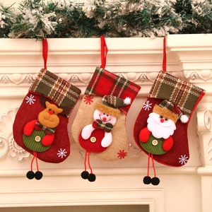 Detailed close-up of three Christmas stockings with Santa and reindeer on a white mantel