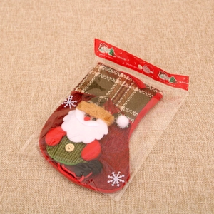 Detail of a plush Santa Claus Christmas stocking with snowflake embroidery and red hanger