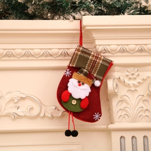 Detail of Christmas stocking with 3D Santa Claus hanging on fireplace mantel