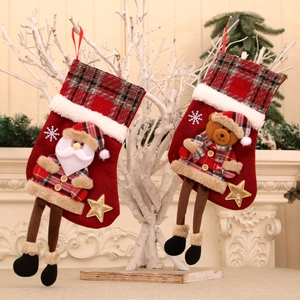 Detail of Christmas stocking ornaments featuring 3D Santa and bear with plaid accents