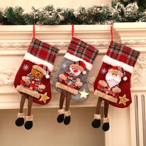 Detailed view of Christmas stockings with Santa, snowman and bear hanging on a fireplace