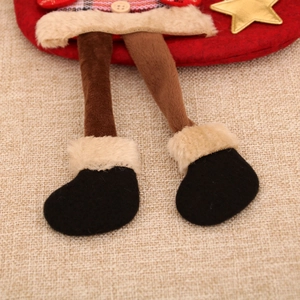 Detail of Christmas stocking featuring red felt, plaid fabric, and wooden button accent