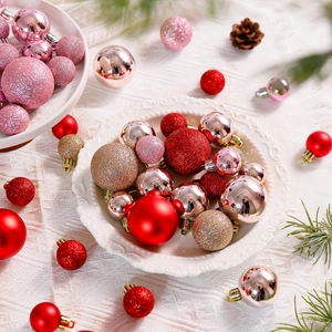 Macro view of assorted Christmas ball ornaments in red, pink and gold with glitter textures