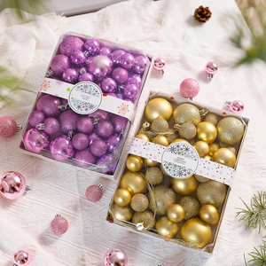 Close-up of purple and gold Christmas ball ornaments set with matte and glitter finishes